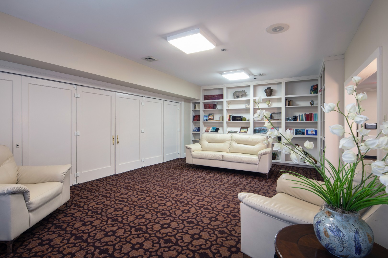 Community lounge with bookshelves and comfortable sofas